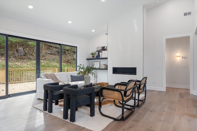 interior space with high vaulted ceiling, recessed lighting, visible vents, and light wood-style floors