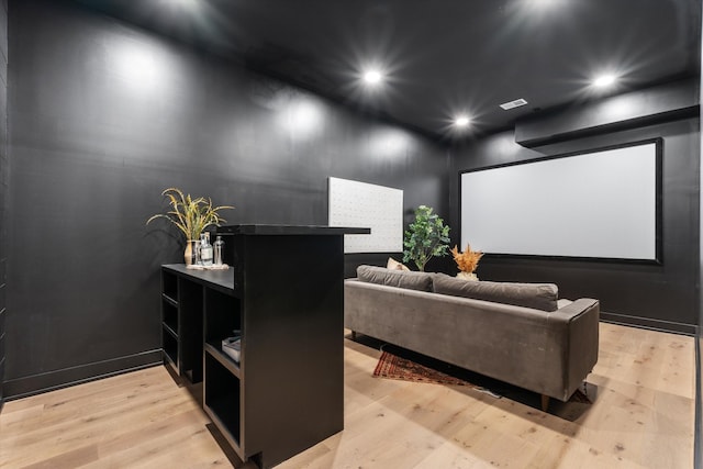 cinema room with visible vents, light wood-style flooring, and recessed lighting