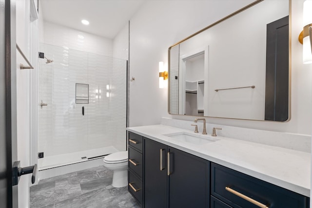 bathroom with toilet, a shower stall, recessed lighting, and vanity