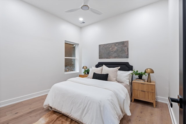 bedroom featuring light wood finished floors, recessed lighting, a ceiling fan, and baseboards