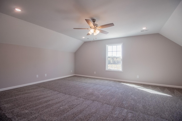 additional living space with carpet, vaulted ceiling, baseboards, and ceiling fan