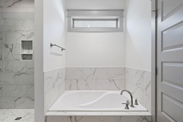 full bathroom featuring a marble finish shower and a bath