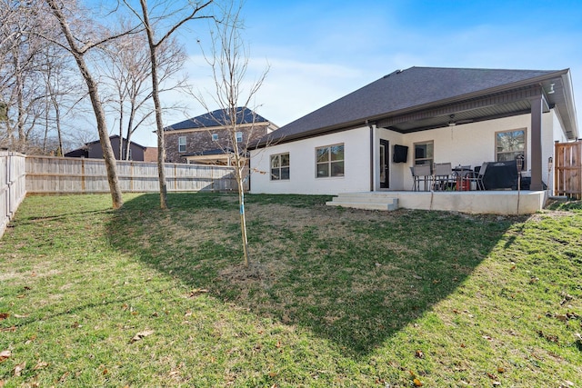 back of house with a ceiling fan, a fenced backyard, a patio, and a lawn