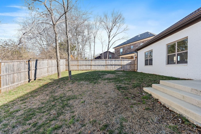 view of yard with a fenced backyard