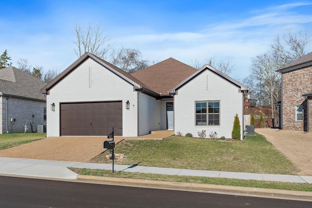 single story home with a front yard, brick siding, an attached garage, and central air condition unit