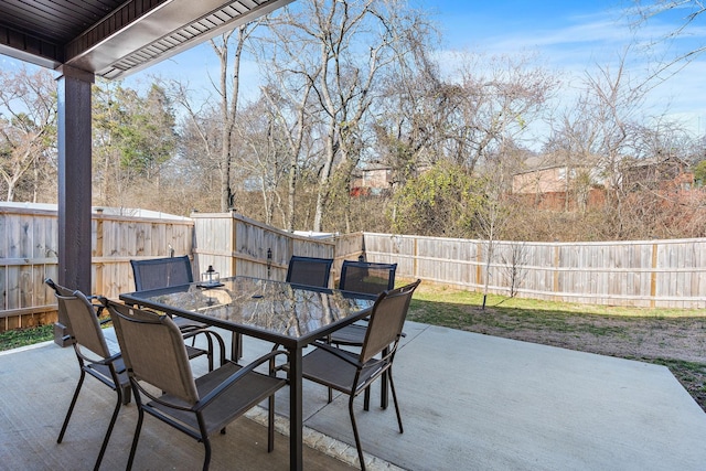 view of patio featuring outdoor dining space and a fenced backyard