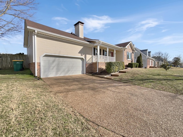 view of front of property with brick siding, a chimney, concrete driveway, a front yard, and fence