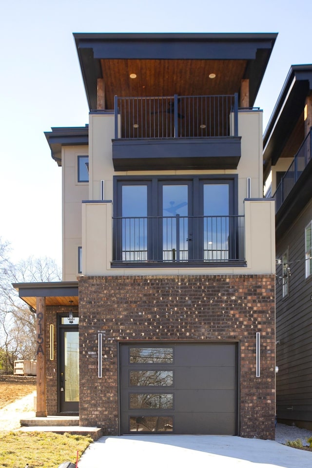 view of building exterior featuring driveway and an attached garage