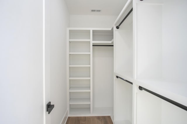 walk in closet with wood finished floors and visible vents