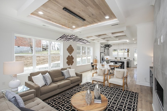 living room featuring baseboards, wooden ceiling, light wood-style floors, a fireplace, and recessed lighting