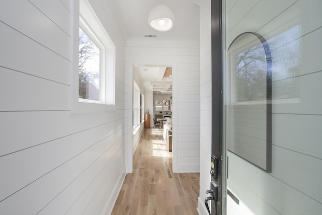 hallway with light wood-style flooring and visible vents