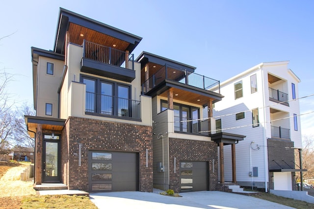 view of front of property with brick siding, driveway, and an attached garage