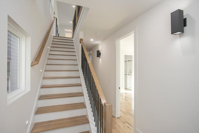 stairway with recessed lighting and wood finished floors