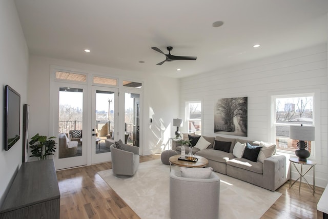 living room with light wood-style floors, ceiling fan, french doors, and recessed lighting