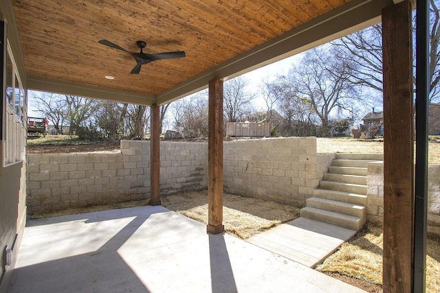 view of patio / terrace with stairs, fence, and a ceiling fan