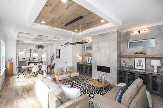 living room featuring light wood-style floors, recessed lighting, wooden ceiling, and a raised ceiling