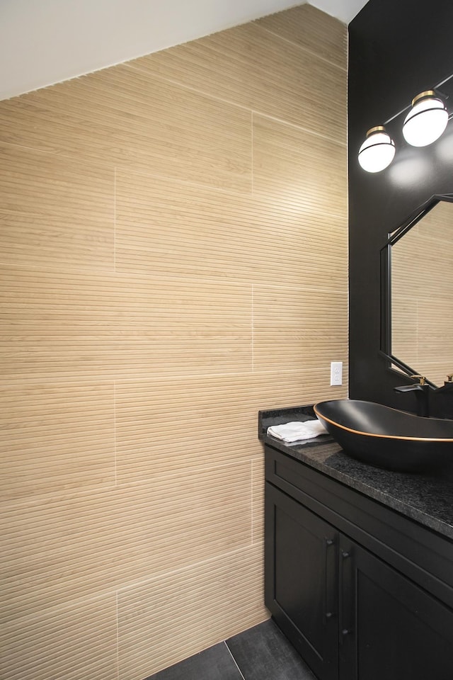 bathroom featuring tile walls and vanity