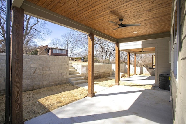 view of patio with a ceiling fan, a fenced backyard, stairway, and central AC unit