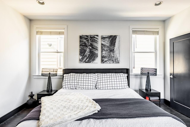 bedroom featuring baseboards, dark wood-type flooring, and recessed lighting