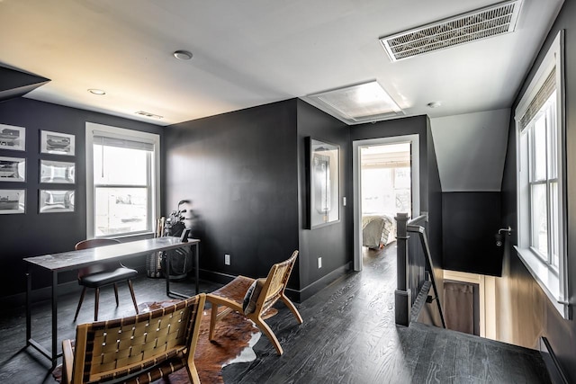 office area with baseboards, visible vents, and dark wood-type flooring