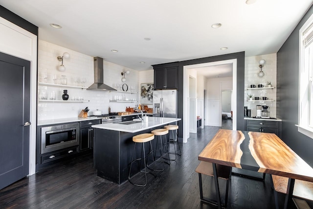 kitchen with open shelves, wall chimney exhaust hood, appliances with stainless steel finishes, and light countertops