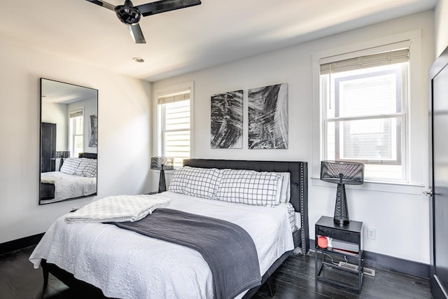 bedroom featuring baseboards, dark wood finished floors, and a ceiling fan