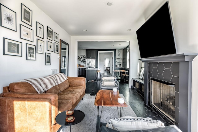 living area featuring a tile fireplace