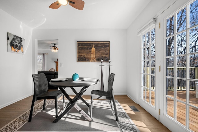 dining room with wood finished floors, visible vents, and a healthy amount of sunlight