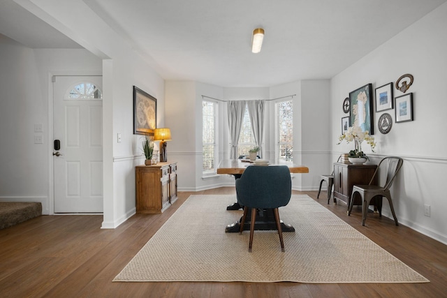 office area with dark wood-style flooring and baseboards