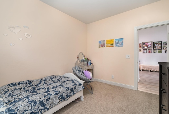 carpeted bedroom featuring baseboards