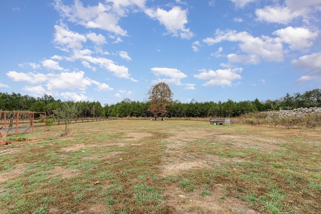 view of yard with a rural view and fence