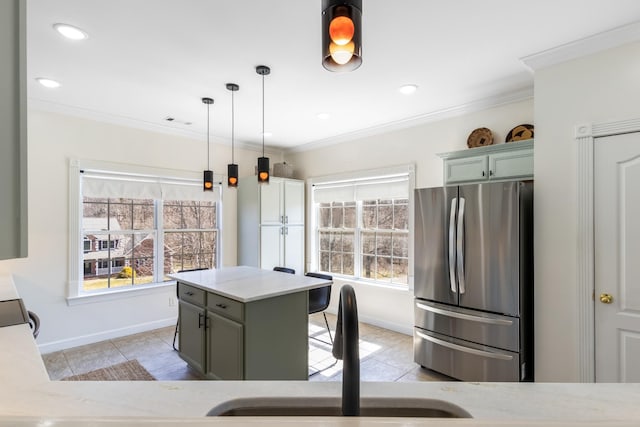 kitchen with ornamental molding, freestanding refrigerator, and a healthy amount of sunlight