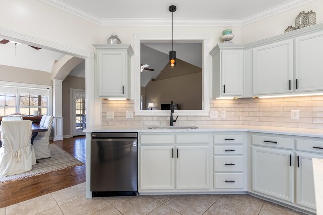 kitchen featuring tasteful backsplash, a ceiling fan, light countertops, stainless steel dishwasher, and a sink