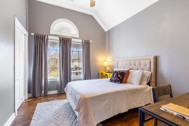 bedroom with vaulted ceiling, wood finished floors, a ceiling fan, and baseboards