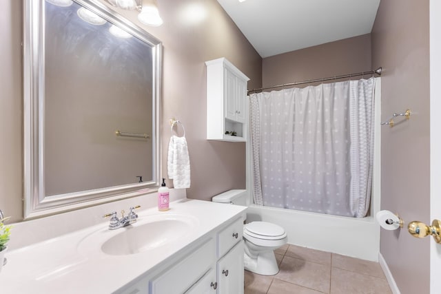 bathroom featuring toilet, vanity, shower / bath combo with shower curtain, and tile patterned floors