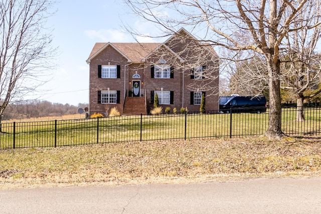 view of front facade featuring fence and brick siding