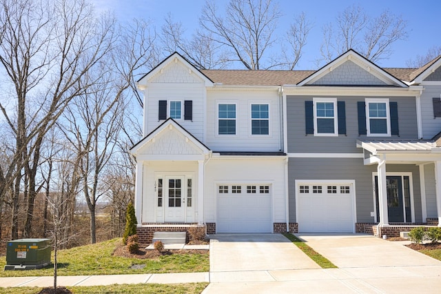 view of front of house featuring a garage, concrete driveway, and brick siding