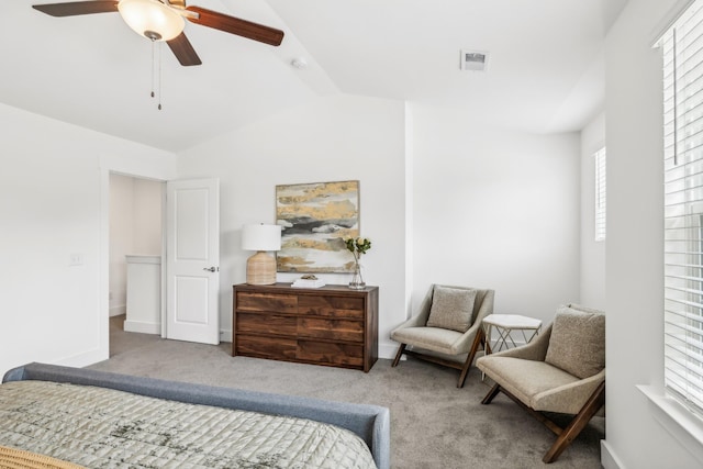 carpeted bedroom with baseboards, visible vents, vaulted ceiling, and a ceiling fan