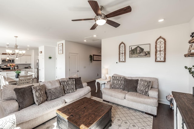 living area with recessed lighting, baseboards, light wood finished floors, and ceiling fan with notable chandelier