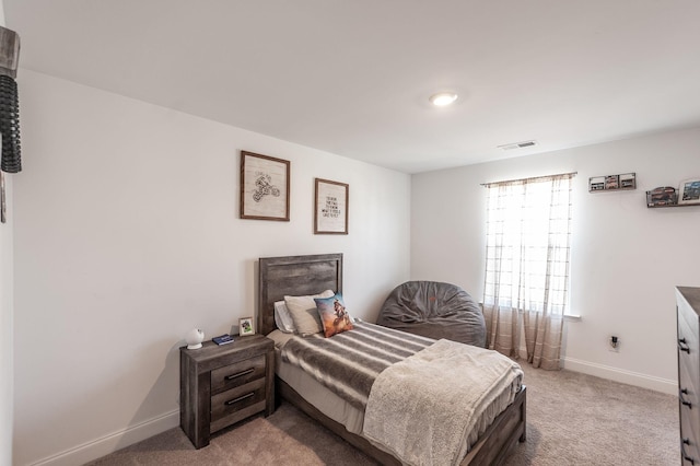 bedroom with light carpet, visible vents, and baseboards