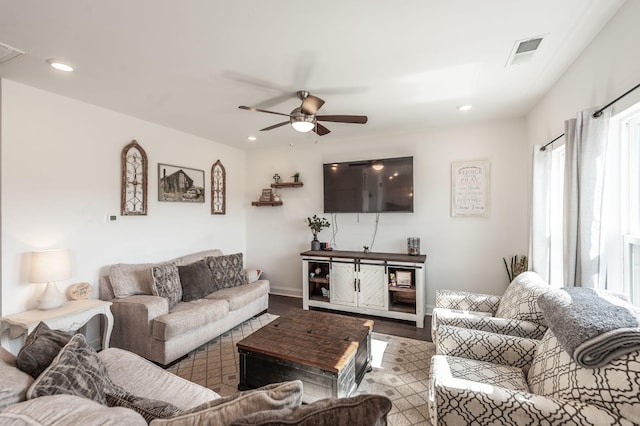 living area with recessed lighting, visible vents, ceiling fan, light wood-type flooring, and baseboards