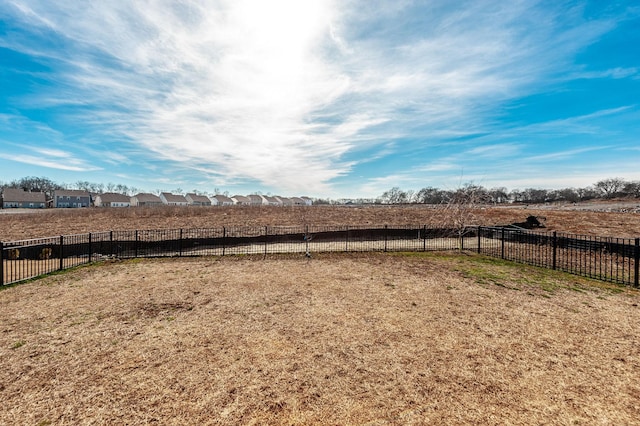 view of yard featuring a rural view and fence