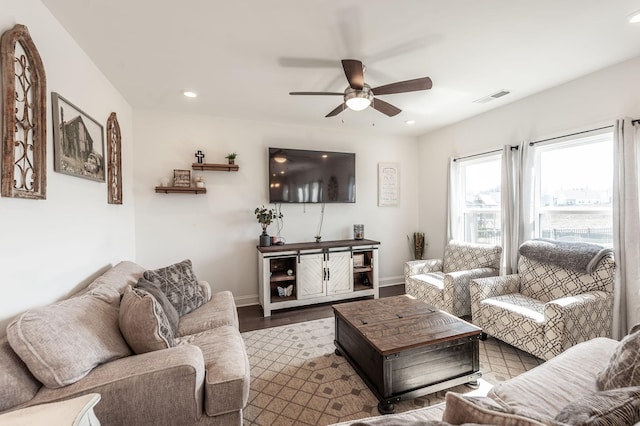 living area with baseboards, wood finished floors, visible vents, and recessed lighting