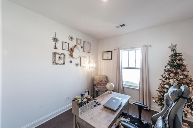 office with dark wood finished floors, visible vents, and baseboards