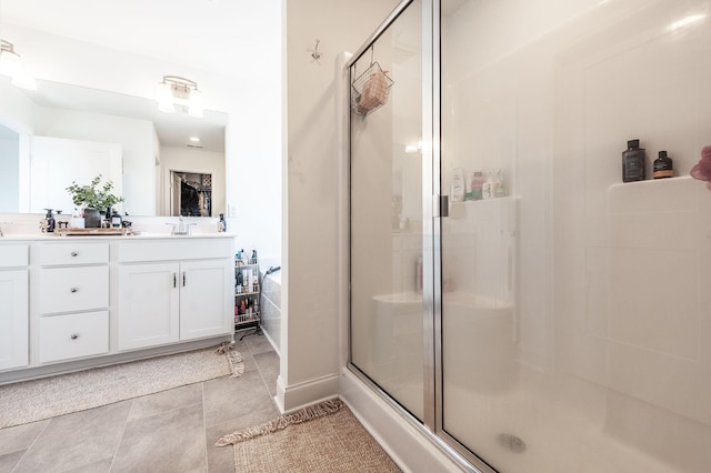 bathroom with a sink, double vanity, tile patterned flooring, and a shower stall