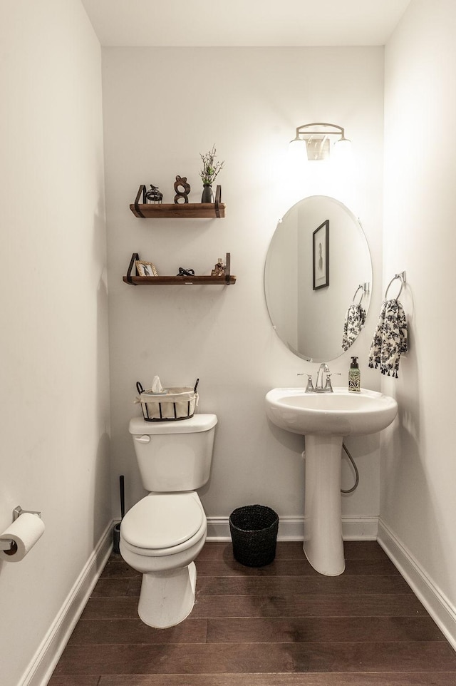 bathroom featuring wood finished floors, toilet, and baseboards