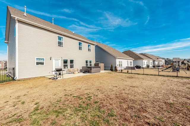 rear view of house featuring a hot tub, a patio, a fenced backyard, a residential view, and a playground