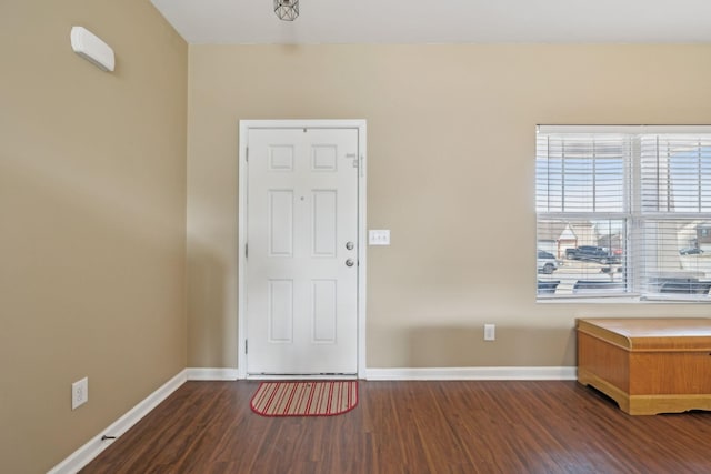 foyer entrance with wood finished floors and baseboards