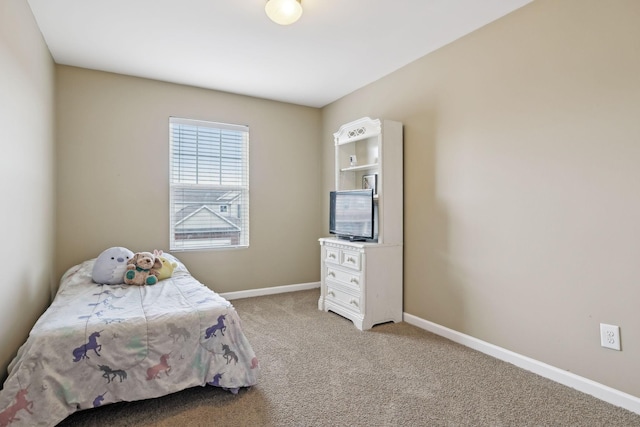 bedroom featuring baseboards and light colored carpet