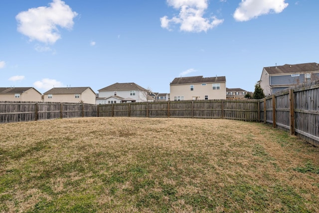 view of yard with a residential view and a fenced backyard